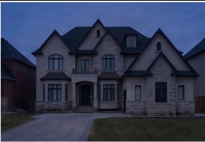 The same house at dusk with the system switched off — nothing on the roofline reads as installed hardware.